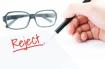 Closeup of approved signature with fingers and pen