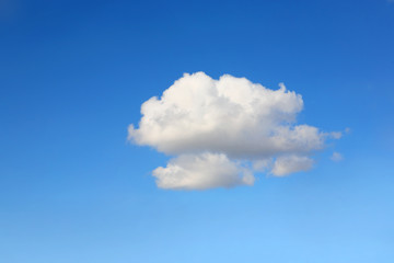 Naklejka na ściany i meble Single cumulous cloud on a blue sky
