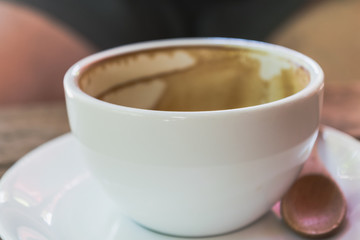 Close up empty white cup of Coffee on the wooden table.