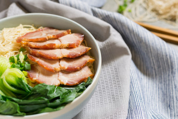 delicious egg noodle with red pork and vegetable in bowl decorat
