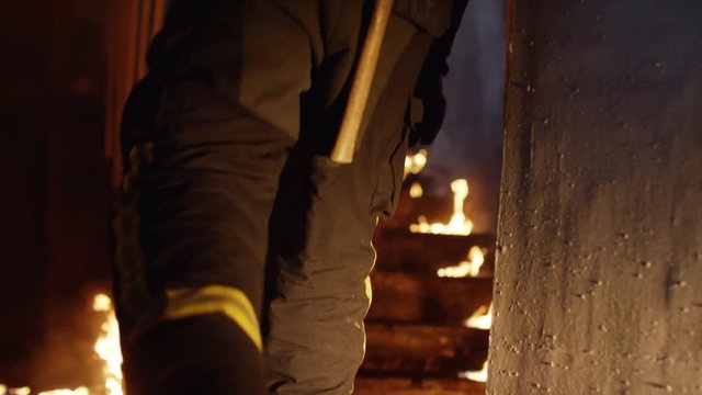 Two Brave Firefighters Go Up Burning Stairs. They Go Through Open Doors. Building is on Fire. Open Flames and Smoke Everywhere. Slow Motion. Shot on RED EPIC (uhd).