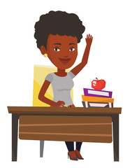 Student raising hand in class for an answer.