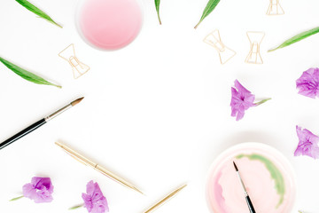 Artist workspace. Frame watercolor, paintbrushes, golden pen and clips, green leaves. Flat lay, top view