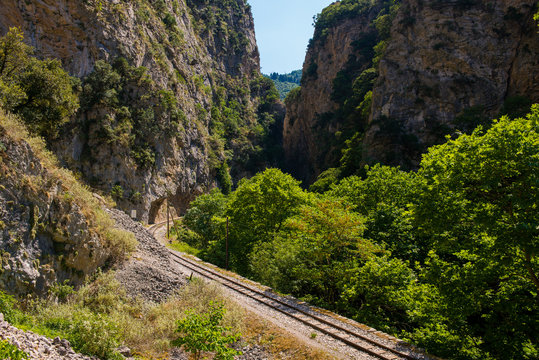 Railroad tracks on the old worn wooden sleepers require urgent repair. The narrow-gauge railway along the ridge. The narrowest railway in the world, railway in the mountains
