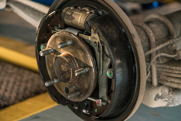 brake pads and cylinder brake drum close up.
Rear drum brake assembly on suv and pick up car