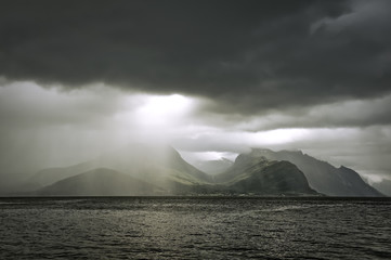 Norwegian landscape. The ray of light makes its way from behind the clouds. The county of More og Romsdal. Norway.