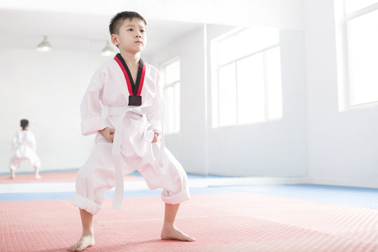 Cute boy practicing Tae Kwon Do