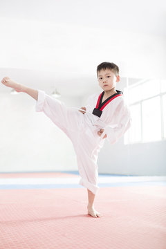 Cute boy practicing Tae Kwon Do