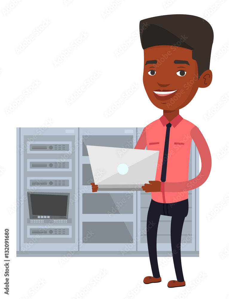 Poster engineer working on laptop in network server room.