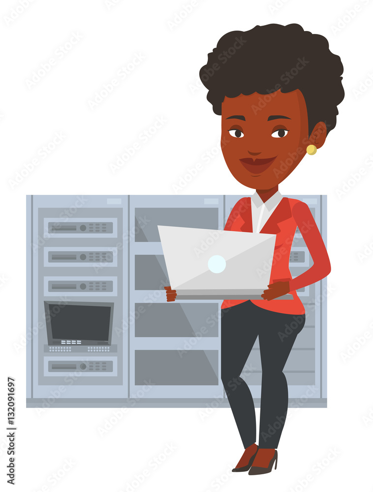 Poster engineer working on laptop in network server room.