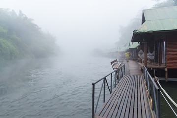 Resort wooden house floating and beautiful mountain fog on river Kwai at Sai yok,Kanchanaburi,Thailand