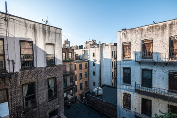 Fototapeta na wymiar Brownstones and urban dwellings in between blocks in New York City