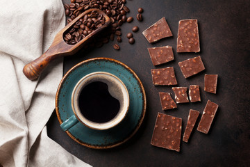 Coffee cup and chocolate on old kitchen table