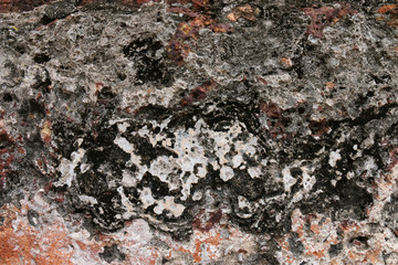 Weathered stone wall background of the ancient city.
