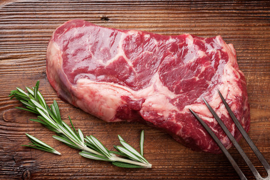 Raw ribeye beef steak cooking