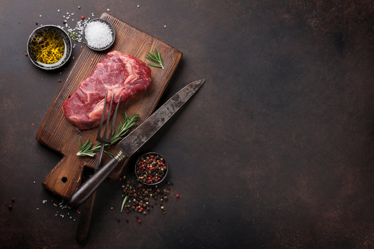 Raw ribeye beef steak cooking