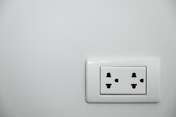 White plug socket on the wall