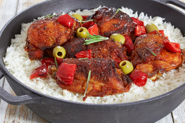 rice with grilled chicken thighs, red bell pepper, green olive