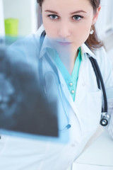 Radiologist woman checking x-ray, medical and radiology concept
