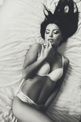 Naklejka premium View at attractive woman in the bed