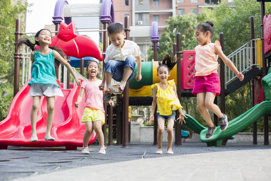 Cheerful children playing in playground