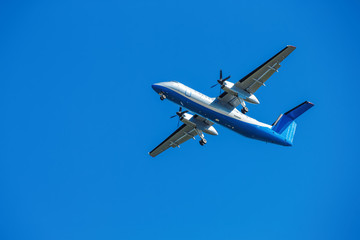 wide-body plane is flying in blue sky