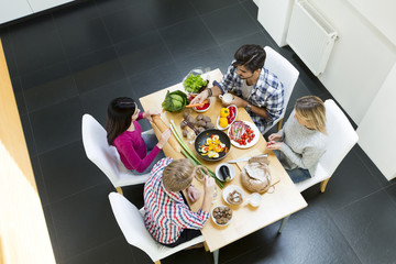 Young people having meal in the modern kitchen