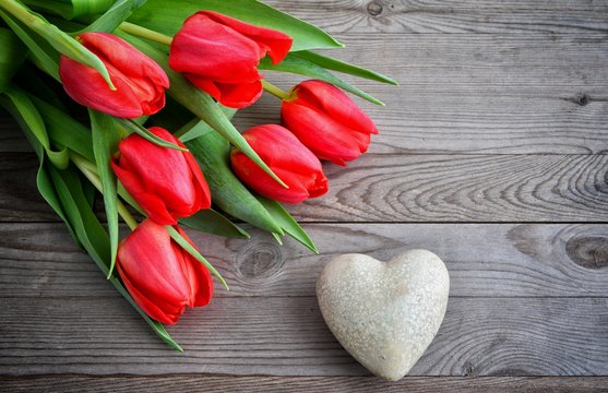 Valentines Day background with heart and red tulips