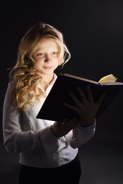 photo of young girl reading book
