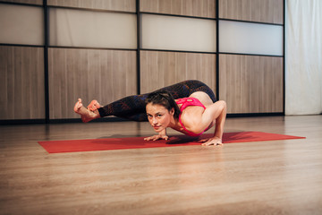 Fototapeta premium Beautiful young woman yoga workout in gym