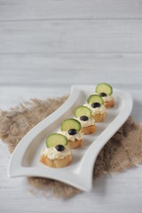 Waiter carrying plates with cheese dish on some festive event, party or wedding reception