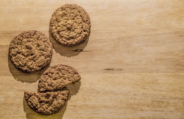 Oatmeal cookies on a wooden board. Brown background for an inscription