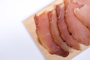 Sliced smoked sirloin on the wooden board with copy space