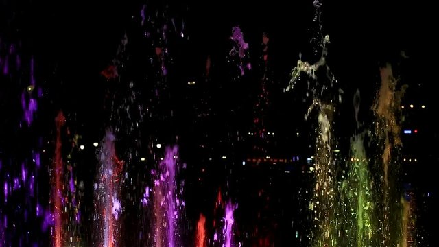 Water splashes lit with random colors