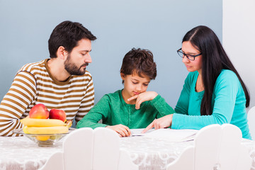 Parents are teaching their son at home.