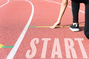 Athlete on starting line waiting for the start in running track