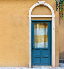 Green Door with orange walls.