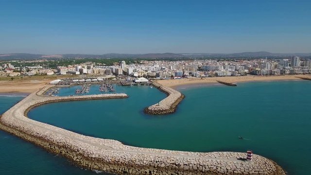 Aerial. Fishing port with boats, filmed from the sky drone in Quarteira.