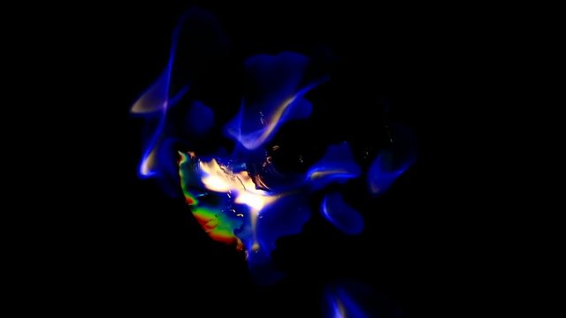 Top view of a CD, DVD burning with blue flames