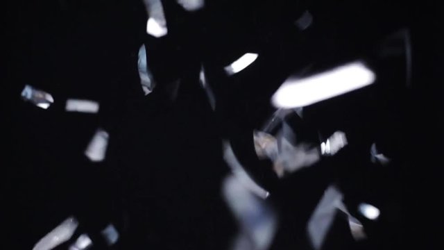 silver confetti falling over black background