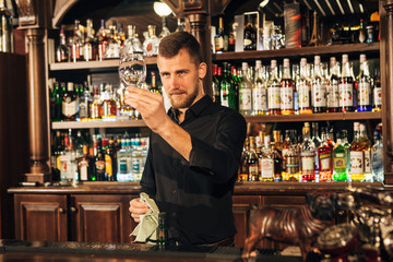bartender is wiping a glass