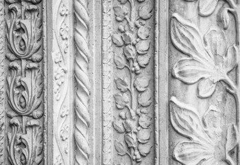 Carved stone decorations, outside a church in Italy.(black and white version).