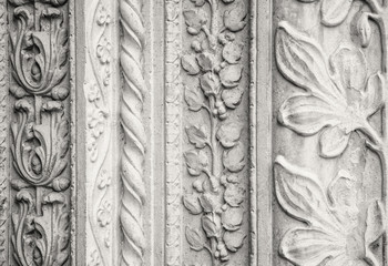 Carved stone decorations, outside a church in Italy. (sepia version).