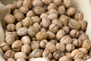 Background image of a basket full of a raw walnuts.