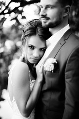 Young wedding couple enjoying romantic moments outside on a summer meadow