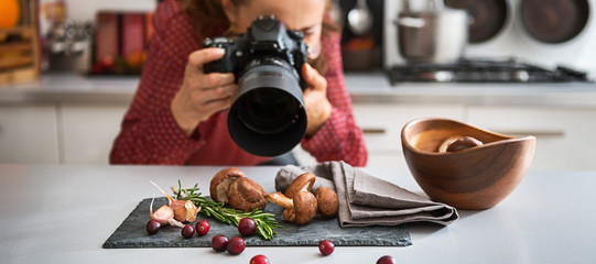 Woman food photographer taking closeup of mushrooms