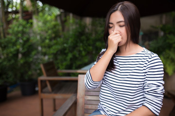 Woman has sneezing at coffee shop