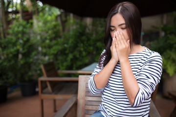 Woman has sneezing at coffee shop