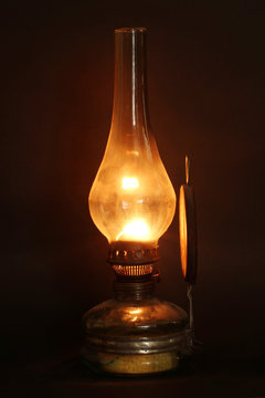 Old lamp illuminates darkness of the night.