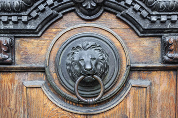 Antique bronze handle on old wooden door